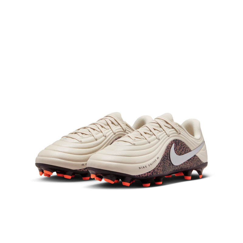 Youth soccer cleats in cream with silver Nike swoosh, burgundy patterned side, orange accents