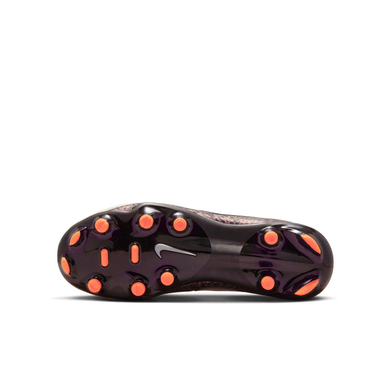 Sole view of youth soccer cleats: black outsole with orange stud tips