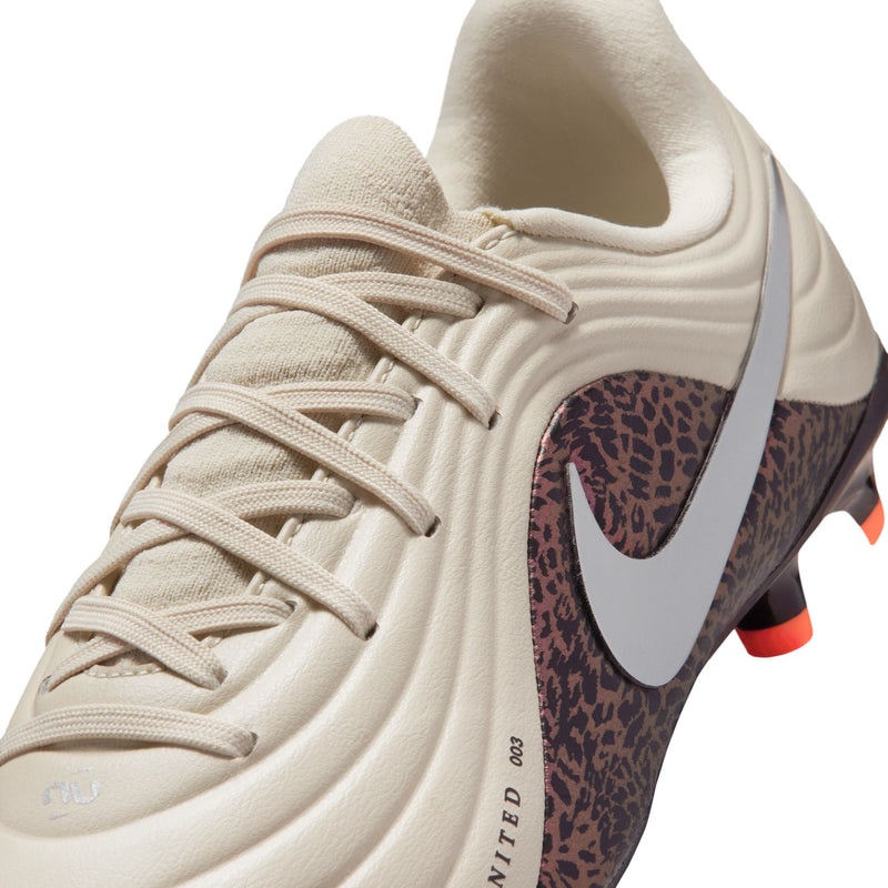 Close-up of youth soccer cleats: cream laces, burgundy leopard collar panel, silver swoosh