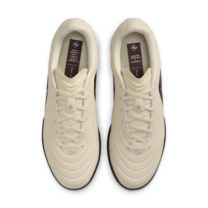 Beige Nike Tiempo Maestro TF shoes, front openings showing laces and interior branding
