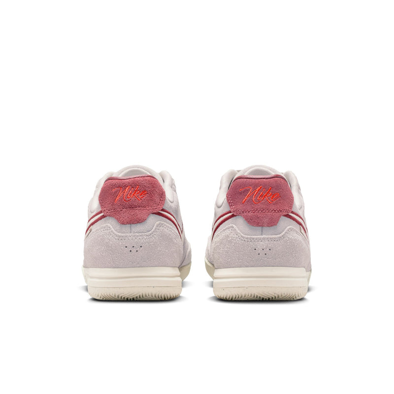 Men's low-top sneakers heel view with red heel tab and light gray suede upper