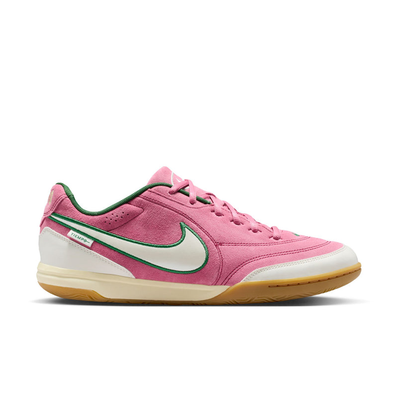 Men's pink low-top sneakers with green swoosh, white midsole, and gum outsole