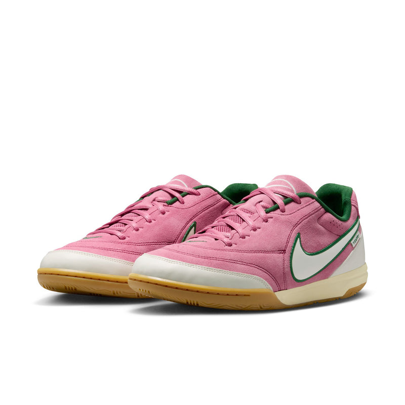 Pair of men's pink low-top sneakers with green accents, white sides, and gum sole