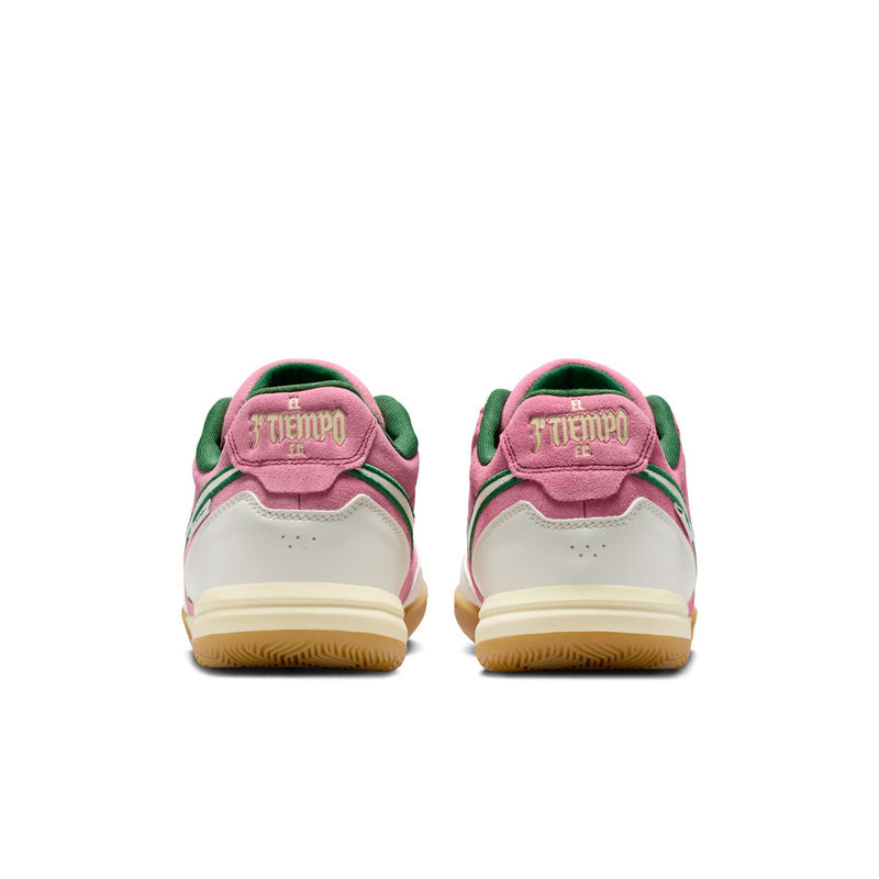 Men's pink low-top sneakers with green heel panels, cushioned back tab, and gum sole