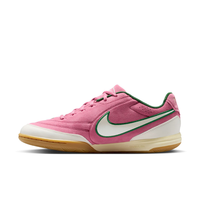 Men's pink low-top sneakers with green swoosh, white midsole, and lace-up front