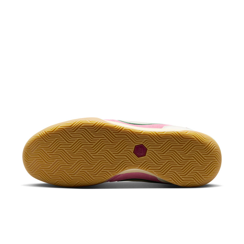 Outsole view of men's pink sneakers with textured gum tread and purple traction patch