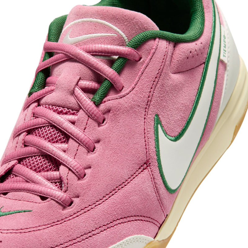 Close-up of men's pink suede sneakers with green laces, Nike swoosh, and stitching details