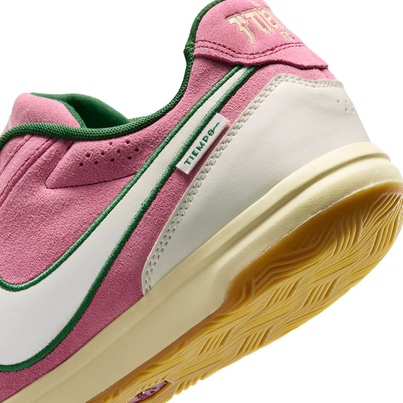 Side close-up of men's pink sneakers with green stripe, 'Tiempo' label, and gum-tinged sole