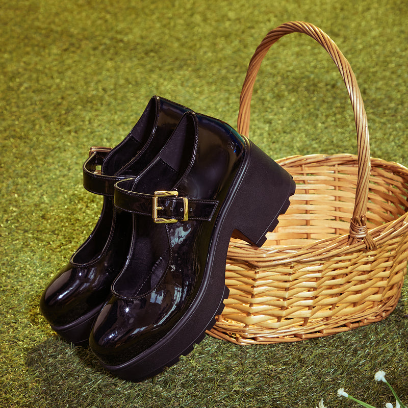 TIRA Black Mary Jane Shoes 'Patent Edition'on a ground with a basket