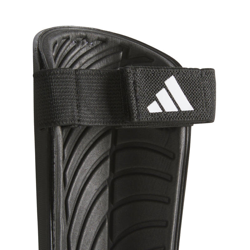 Black shin guard with hook-and-loop strap and adidas logo on front
