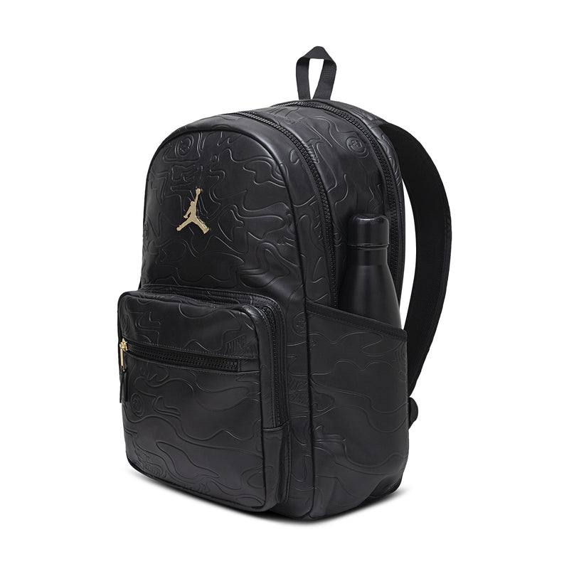 Black topographic backpack, side view with top handle and side zipper pocket