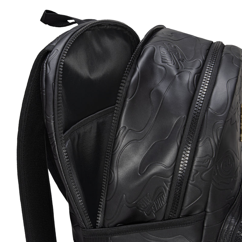Black backpack interior close-up with padded side panels and zipper track