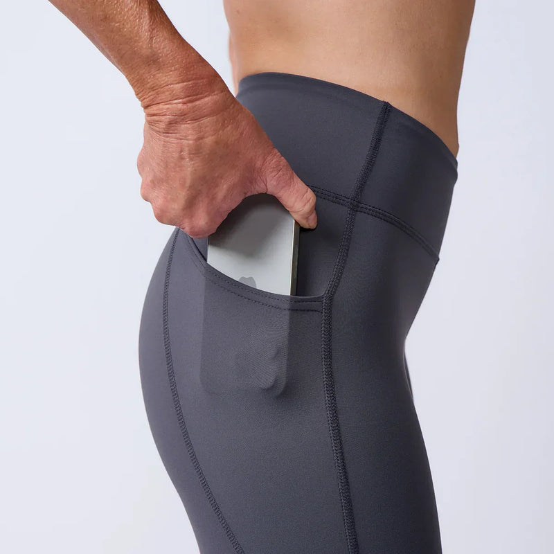 Close-up of a hand placing a phone into the side pocket of GORUCK rucking leggings