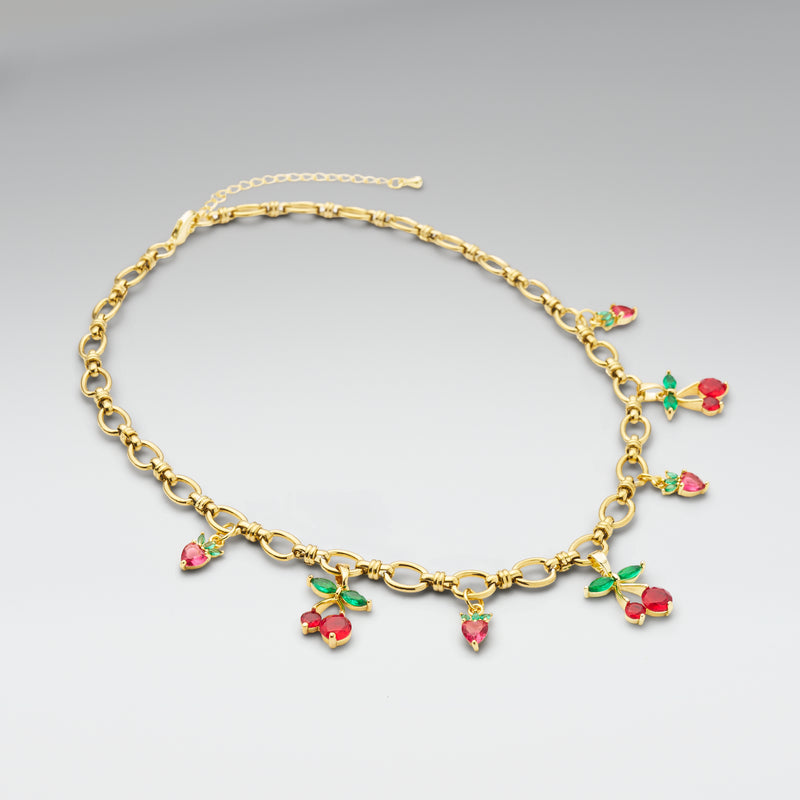 Gold necklace with colorful gemstone pendants on a gray background