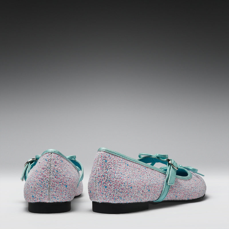 Pair of glittery shoes with green straps on a gray background