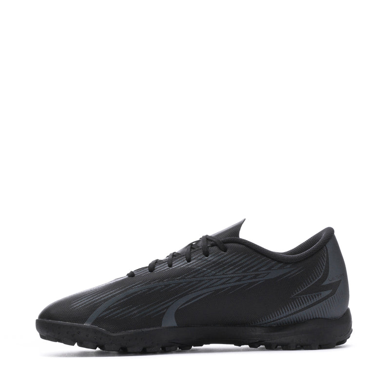 Men's Puma turf soccer shoes, black with copper-pink logo stripe, lace-up profile.