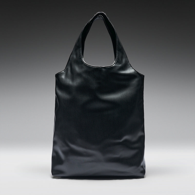 Black leather tote bag on a gradient gray background