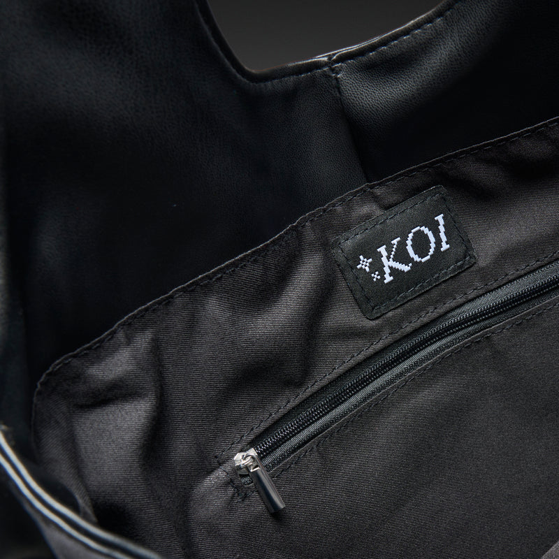 Black bag with a visible brand label on a dark background