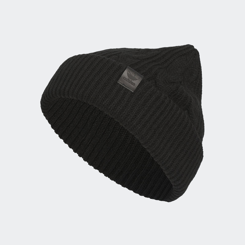 Black cable-knit beanie, diagonal view of ribbed texture and logo patch.