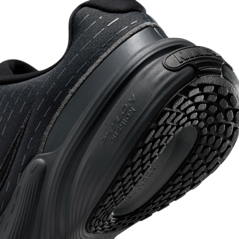 Close-up of black outsole and tread pattern with cushioned midsole edge