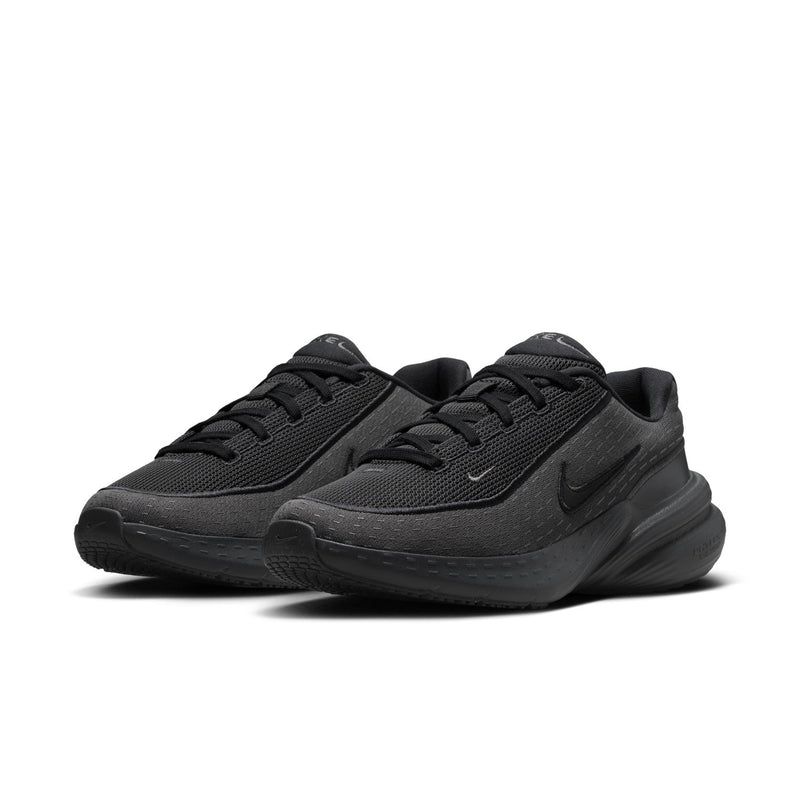 Women's dark lace-up running shoes, pair view with Nike swoosh and sculpted midsole
