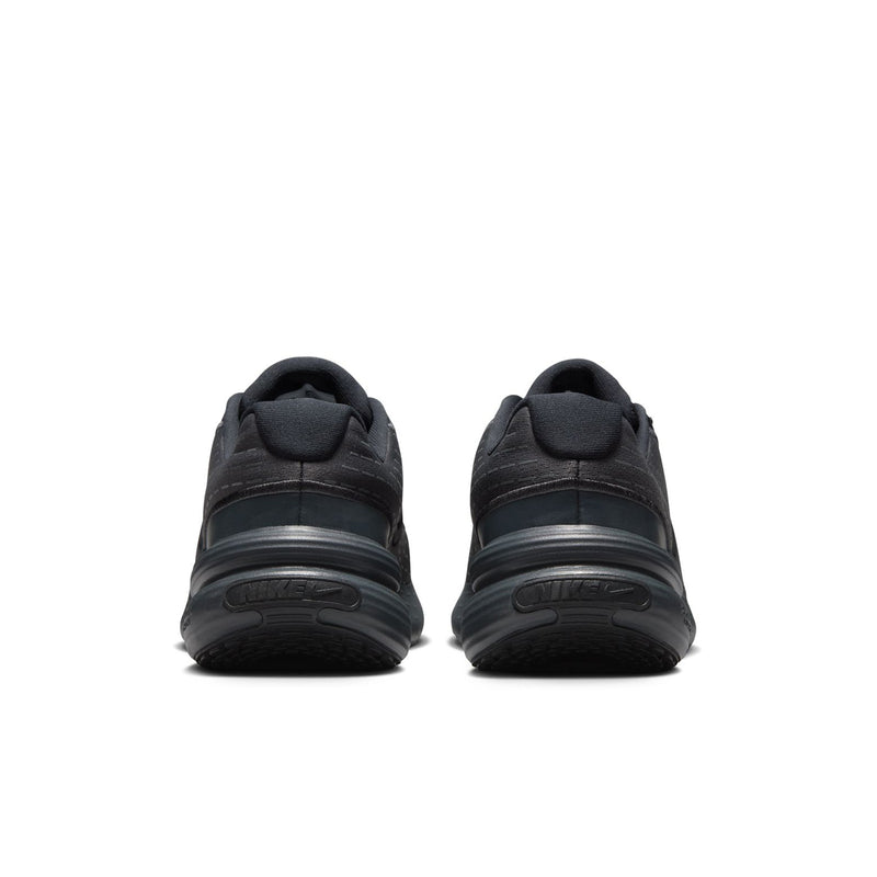 Women's black sneakers, rear view with heel pull tab and sculpted rubber sole