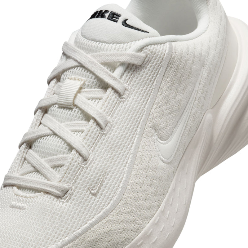 Close-up of white mesh upper with laces and stitched Nike Swoosh