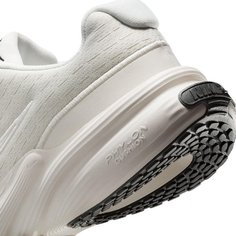 Side and sole close-up with white cushioning, embossed text, and black tread