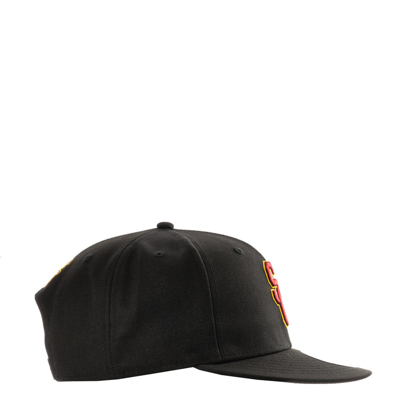 Black baseball cap side profile with red and yellow USC logo patch