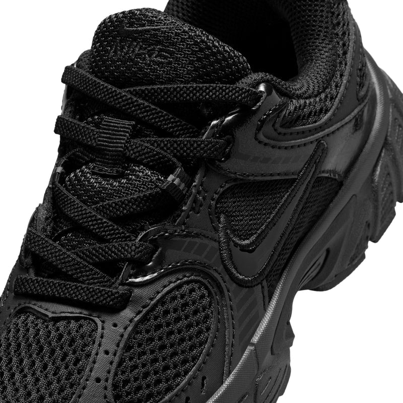 Close-up of kids black lace-up running shoes: mesh upper, eyestays, and swoosh
