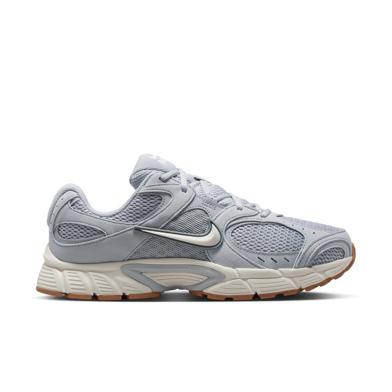 Men's light gray running shoes with mesh uppers, Nike swoosh, and gum-brown outsole