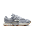 Men's light gray running shoes with mesh uppers, Nike swoosh, and gum-brown outsole