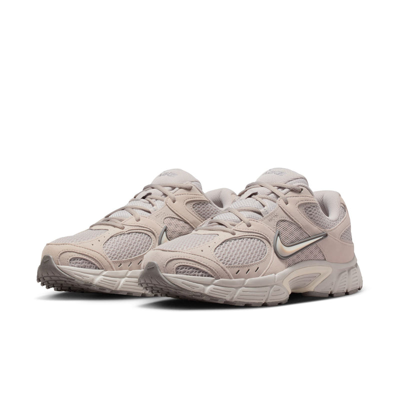 Men's beige Nike lace-up running shoes with two-tone overlays and chunky midsole.