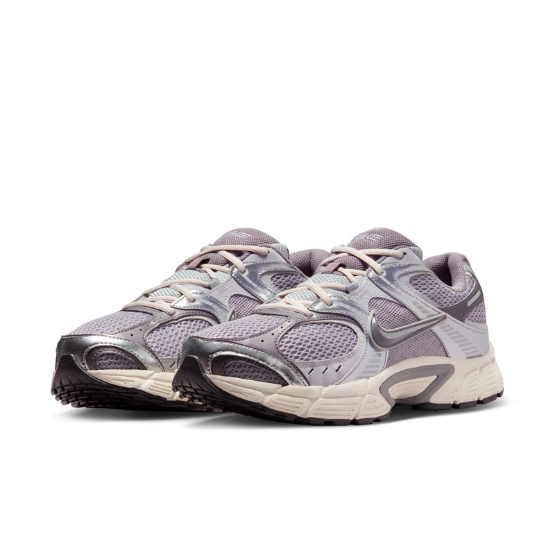 Pair of gray Nike running sneakers with lace-up front and cushioned off-white sole