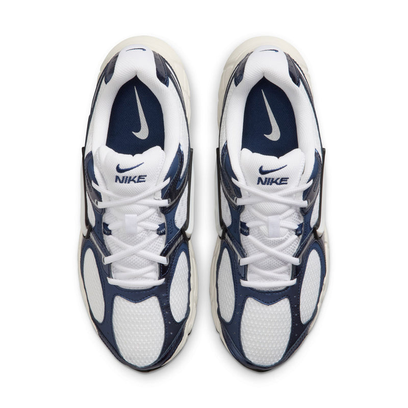 White and midnight navy sneakers showing toe caps and NIKE logos on tongues