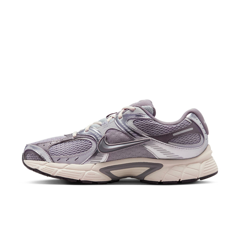 Nike gray running sneaker with lace-up upper and layered off-white midsole