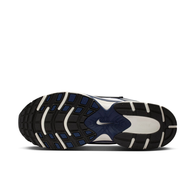 Bottom view of white and midnight navy sneakers with dark tread pattern