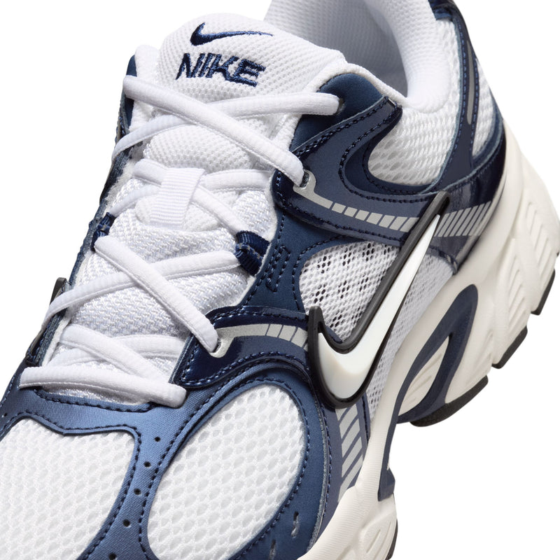 Close-up of white and midnight navy mesh upper with laces and NIKE swoosh