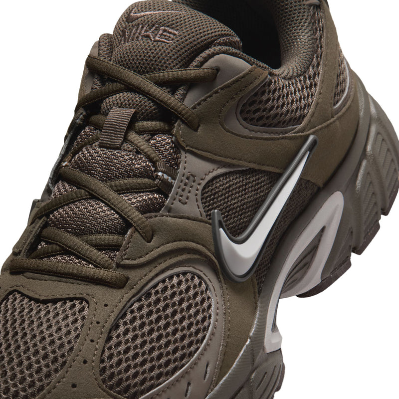 Close-up of olive-brown mesh sneaker upper with Nike Swoosh and laces