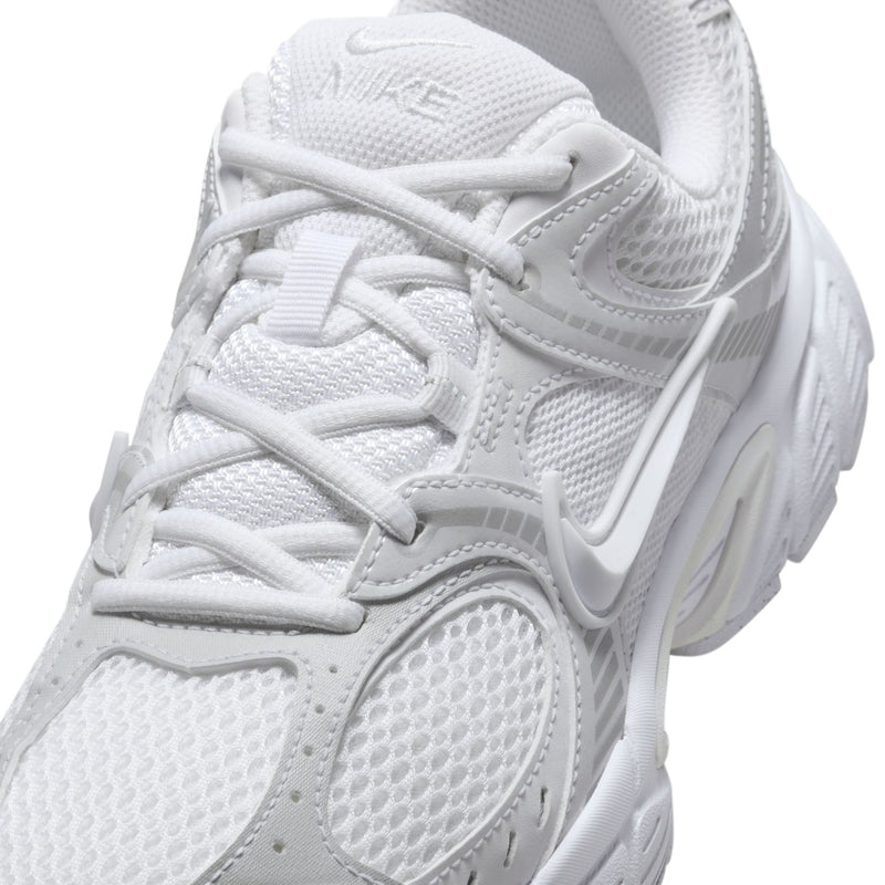 Close-up of white mesh running sneaker upper with laces and Swoosh logo
