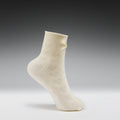 White sock with a subtle pattern on a gray background