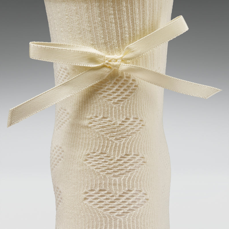 Beige textured dress with a bow on a gray background