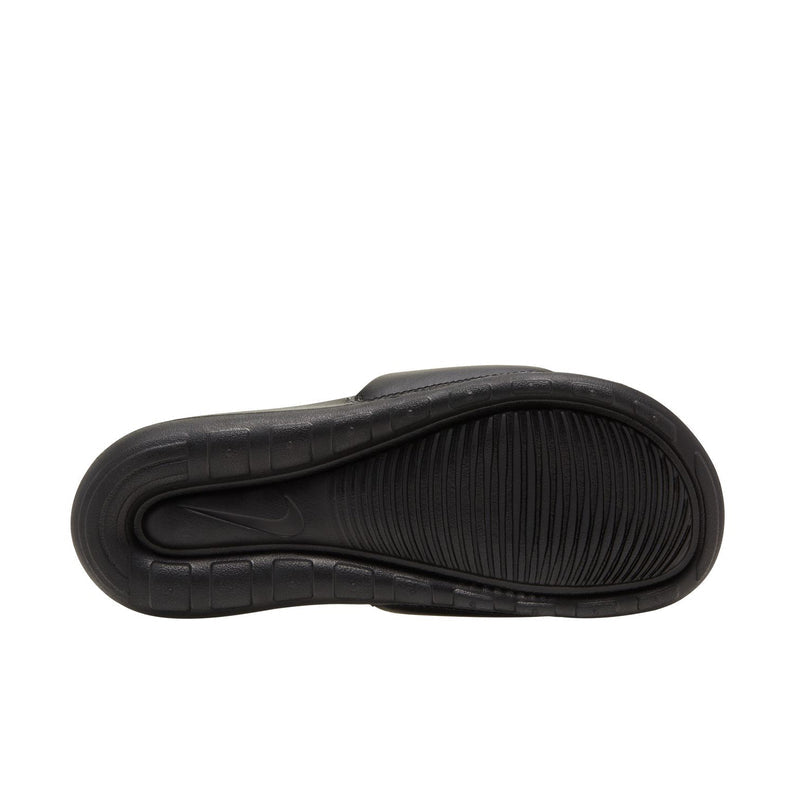 Black slide sandal outsole view with patterned tread and smooth sidewall.