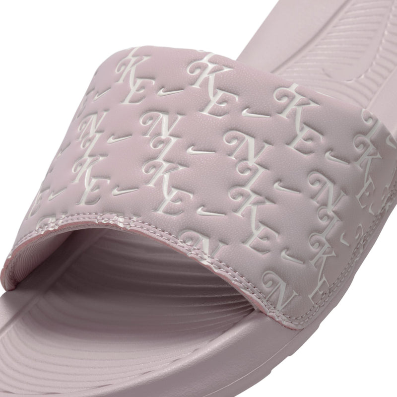 Close-up of mauve-pink slide sandal strap with embossed logo pattern and cushioned lining
