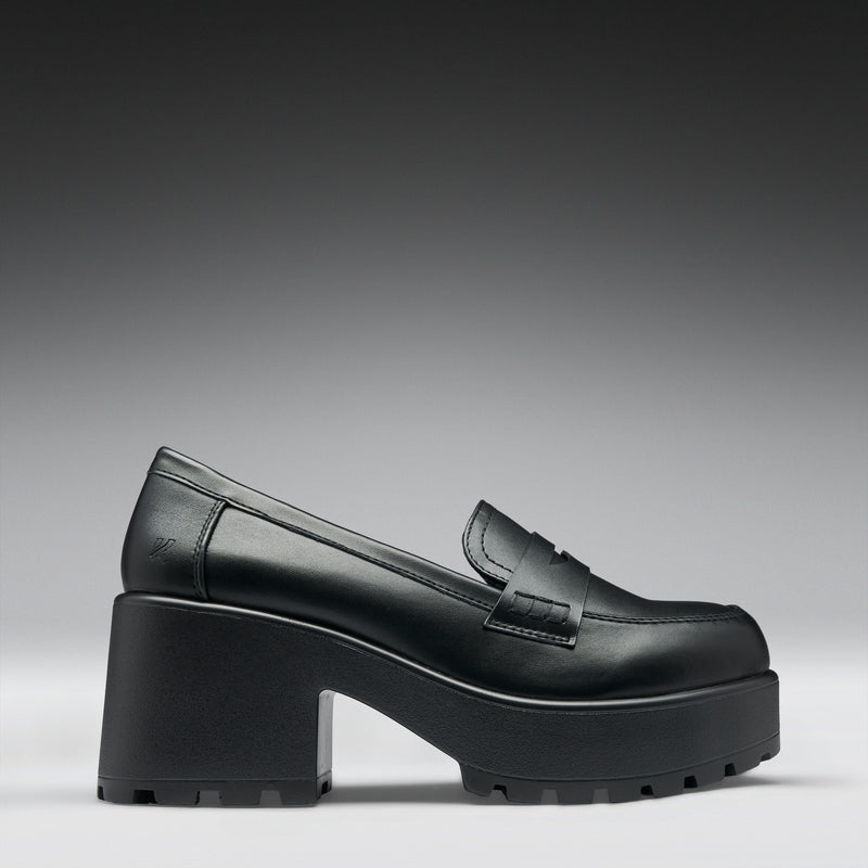 Black platform loafer shoe on a gray background
