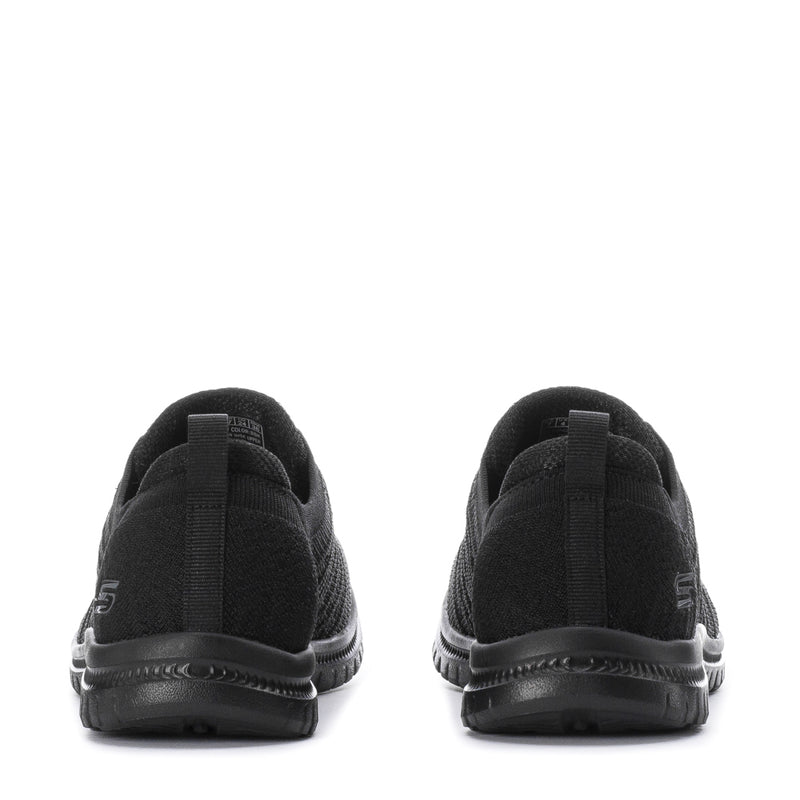 Black women's wide knit sneakers, back view showing heel cushioning, pull tab, and tread sole