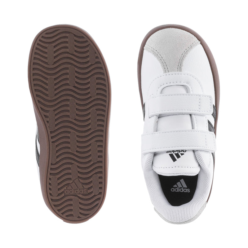 White toddler sneaker with brown outsole view and stitched strap detail, Adidas logo