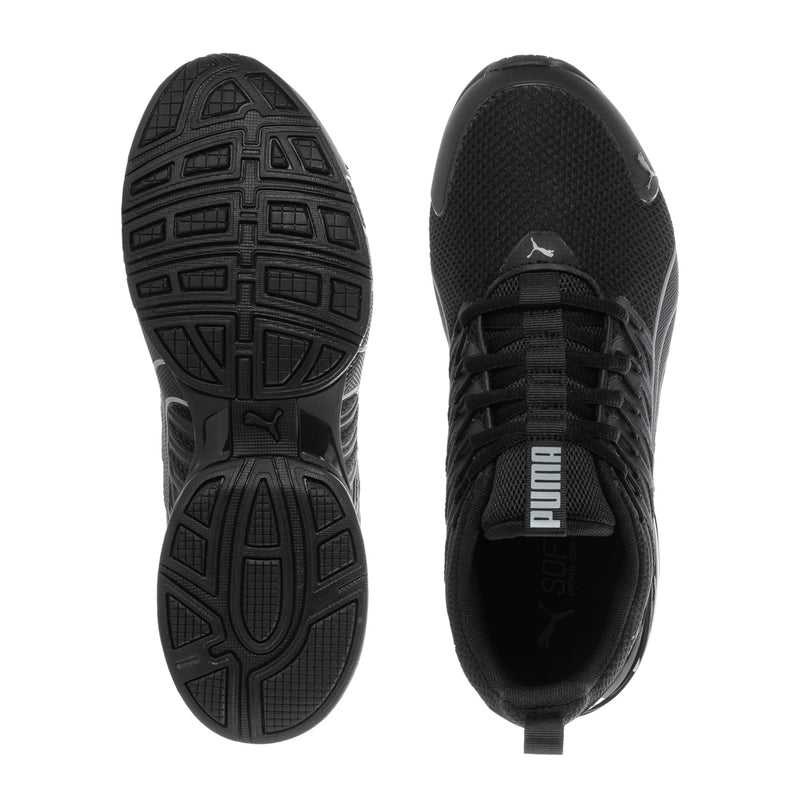 Youth black Puma sneakers bottom and side view, textured tread sole and lace-up upper