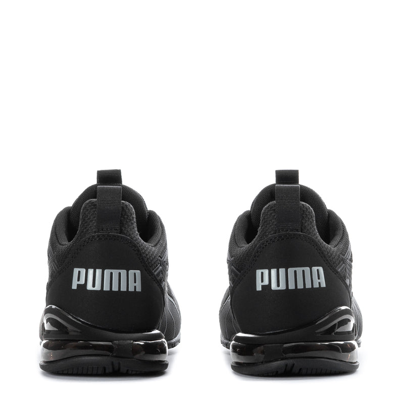Youth black Puma sneakers back view with PUMA logo and cushioned heel