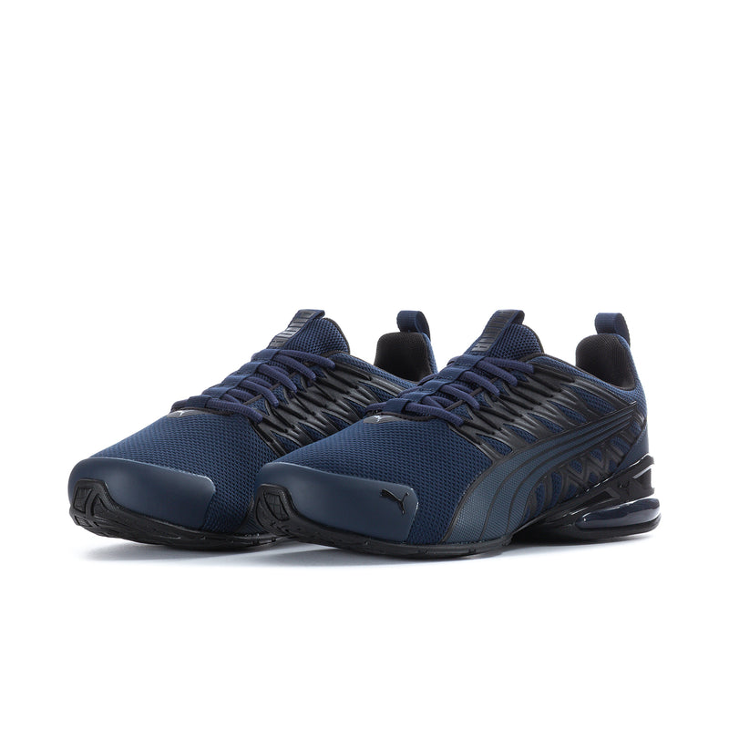 Navy athletic sneakers with cushioned heel, textured laces, and dark tread sole